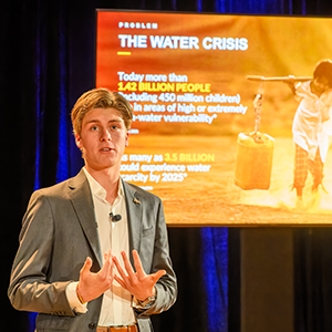 A man in a suit jacket speaks about the water crisis