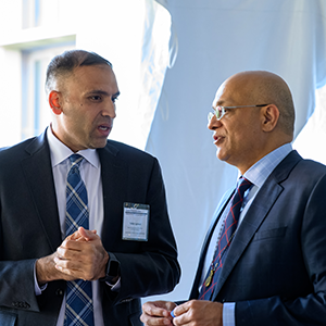 two leaders in suits speak to each other