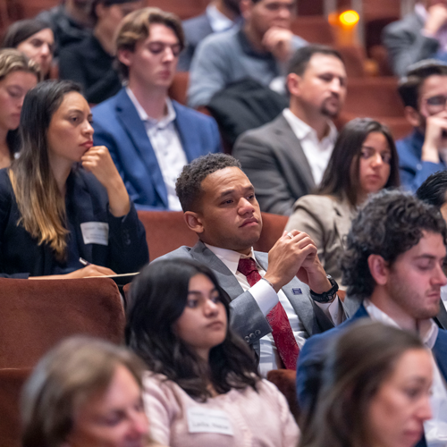 students in the audience listen.